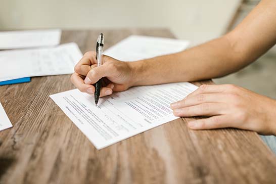 A person filling out a formulary